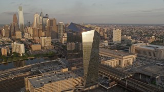 4.8K aerial stock footage of Cira Centre office building in West Philadelphia, reveal skyline of Downtown Pennsylvania, Sunset Aerial Stock Footage | AX80_084E