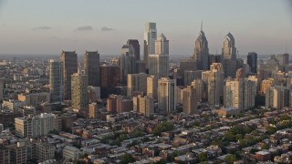 4.8K aerial stock footage of Downtown Philadelphia skyscrapers and urban neighborhoods in Pennsylvania, Sunset Aerial Stock Footage | AX80_092E