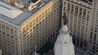 4.8K aerial stock footage of the William Penn statue on top of Philadelphia City Hall, Pennsylvania, Sunset Aerial Stock Footage | AX80_096