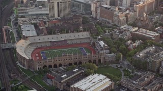 AX80_105 - 4.8K aerial stock footage of Franklin Field at University of Pennsylvania, West Philadelphia, Sunset