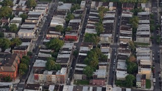 AX80_107 - 4.8K aerial stock footage of row houses and city streets in South Philadelphia, Pennsylvania, Sunset