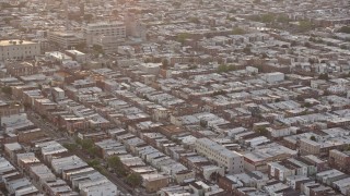 4.8K aerial stock footage flying by an urban neighborhood in South Philadelphia and tilt to the busy street, Pennsylvania, Sunset Aerial Stock Footage | AX80_111