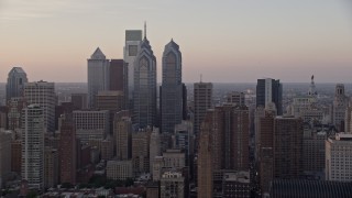 4.8K aerial stock footage flying by Downtown Philadelphia skyscrapers and City Hall, Pennsylvania, Sunset Aerial Stock Footage | AX80_129