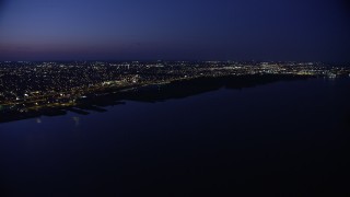 4.8K aerial stock footage of Delaware River and city lights in North Philadelphia, Pennsylvania, Night Aerial Stock Footage | AX81_005