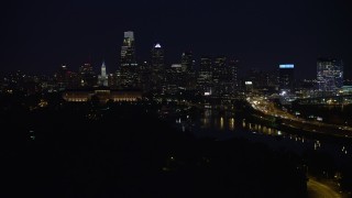 4.8K aerial stock footage of Downtown Philadelphia skyline behind the Philadelphia Museum of Art and the Schuylkill River, Pennsylvania, Night Aerial Stock Footage | AX81_028