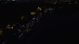 4.8K aerial stock footage of Boathouse Row with lights at night in Philadelphia, Pennsylvania Aerial Stock Footage | AX81_029