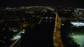 4.8K aerial stock footage approaching and tilting to South Street Bridge over the Schuylkill River, Philadelphia, Pennsylvania, Night Aerial Stock Footage | AX81_077