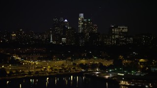 AX81_093 - 4.8K aerial stock footage of Downtown Philadelphia skyline, reveal The Residences at Dockside condo complex, Pennsylvania, Night