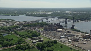 AX82_030 - 4.8K aerial stock footage of Betsy Ross Bridge spanning the Delaware River by the abandoned Richmond Substation, North Philadelphia, Pennsylvania