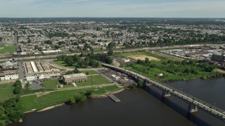 4.8K aerial stock footage of Industrial buildings and factories around Tacony Palmyra Bridge, Philadelphia, Pennsylvania Aerial Stock Footage | AX82_033