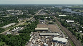 4.8K aerial stock footage flying over warehouse buildings to approach Interstate 276 in Bristol, Pennsylvania Aerial Stock Footage | AX82_050