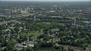 AX82_058E - 4.8K aerial stock footage flying over homes and cemetery in Morrisville, Pennsylvania, approach Trenton, New Jersey across the Delaware River