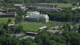 AX82_100 - 4.8K aerial stock footage of Roberts Stadium and Peretsman Scully Hall at Princeton University, New Jersey