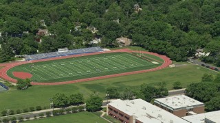 AX82_104 - 4.8K aerial stock footage of Princeton High football field, Princeton New Jersey