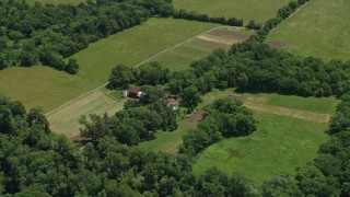 AX83_005 - 4.8K aerial stock footage of farmhouse, barns, and fields in Belle Mead, New Jersey