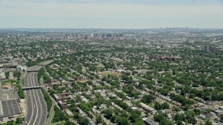 AX83_075 - 4.8K aerial stock footage flying over suburban homes by I-78 to approach Downtown Newark, New Jersey