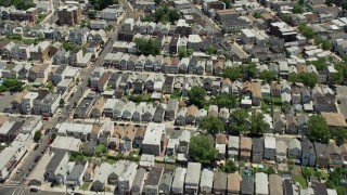 4.8K aerial stock footage tilting from urban Newark homes to reveal and approach Manhattan skyline in the background, New Jersey & New York Aerial Stock Footage | AX83_097