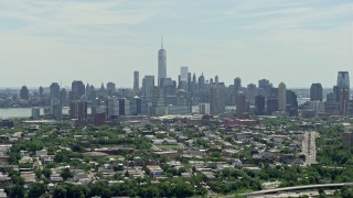 4.8K aerial stock footage of Lower Manhattan skyline behind Downtown Jersey City, New Jersey & New York Aerial Stock Footage | AX83_105