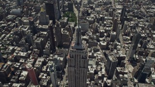 AX83_123 - 4.8K aerial stock footage tilting to bird's eye of Empire State Building and skyscrapers, Midtown Manhattan, New York City