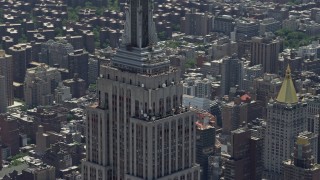 AX83_145 - 4.8K aerial stock footage of upper levels of the Empire State Building, Midtown Manhattan, New York City