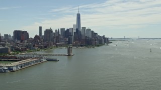 4.8K aerial stock footage tilting from the Hudson River to reveal the World Trade Center, Lower Manhattan skyline, New York City Aerial Stock Footage | AX83_155