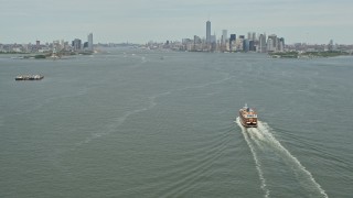 AX83_201E - 4.8K aerial stock footage tilting from Staten Island Ferry on New York Harbor,reveal Jersey City and Lower Manhattan skylines, New York & New Jersey