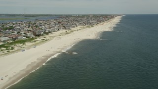 4.8K aerial stock footage of beachgoers and beachfront neighborhoods, Long Beach, New York Aerial Stock Footage | AX83_237