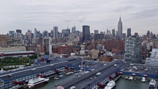 AX84_020E - 4K aerial stock footage flyby Chelsea Piers and office buildings with view of Midtown Manhattan skyscrapers, New York, New York