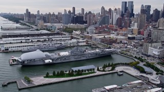 4K aerial stock footage approach and flyby USS Intrepid, Midtown Manhattan, New York City Aerial Stock Footage | AX84_023E