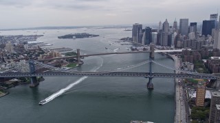 AX84_096E - 4K aerial stock footage flyby Manhattan Bridge, Brooklyn Bridge over East River, reveal Lower Manhattan, New York City