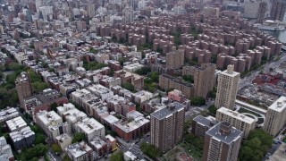 4K aerial stock footage fly over East Village apartment buildings, tilt to reveal Stuyvesant Town and Midtown skyline, New York City Aerial Stock Footage | AX84_129E