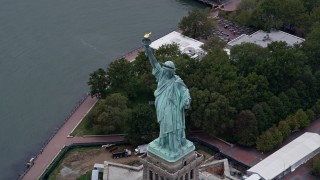 4K aerial stock footage approach the Statue of Liberty and tilt to a bird's eye view, New York Harbor Aerial Stock Footage | AX84_165E