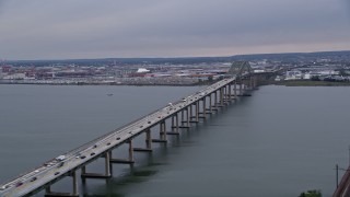 AX84_172 - Aerial stock footage of 4K Aerial Video Flying by Newark Bay Bridge, reveal Lehigh Valley Railroad Bridge, Newark, New Jersey