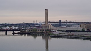 4K aerial stock footage of approaching a waterfront factory in Newark, New Jersey Aerial Stock Footage | AX84_174E