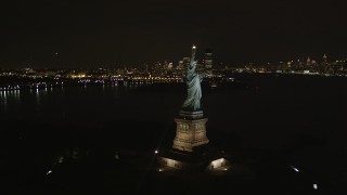 4K aerial stock footage of flying by Statue of Liberty, New York, New York, night Aerial Stock Footage | AX85_004