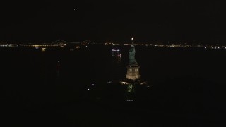 4K aerial stock footage Flying by the side of the Statue of Liberty, New York, New York, night Aerial Stock Footage | AX85_006