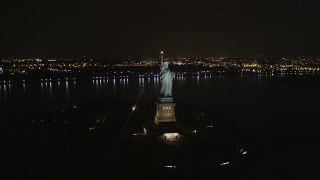 4K aerial stock footage Orbiting the front of the Statue of Liberty, New York, New York, night Aerial Stock Footage | AX85_008