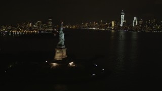 4K aerial stock footage of Statue of Liberty, Lower Manhattan skyline, New York, New York, night Aerial Stock Footage | AX85_009