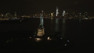 4K aerial stock footage of the Statue of Liberty, Lower Manhattan skyline, New York, New York, night Aerial Stock Footage | AX85_010