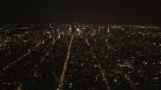 4K aerial stock footage Tilting up from Soho, revealing Midtown Manhattan, New York, New York, night Aerial Stock Footage | AX85_031