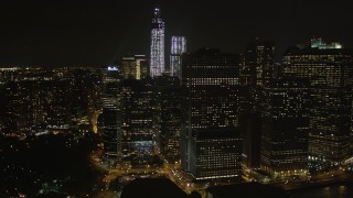 4K aerial stock footage Flying away from Lower Manhattan skyscrapers, New York, New York, night Aerial Stock Footage | AX85_132