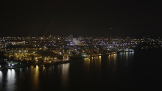 AX85_143 - 4K aerial stock footage of flying by an oil refinery, Newark Bay, Newark, New Jersey, night