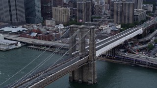 4K aerial stock footage of flying by light traffic on the Brooklyn Bridge, New York City Aerial Stock Footage | AX86_023