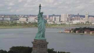 4K aerial stock footage Flying by the side of the Statue of Liberty, Liberty Island, New York, New York Aerial Stock Footage | AX87_010