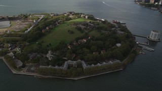 4K aerial stock footage Flying by Governors Island, New York Bay, New York, New York Aerial Stock Footage | AX87_042