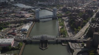 AX87_179 - 4K aerial stock footage Fly over Harlem River, reveal Madison Avenue Bridge, Park Avenue Bridge, New York