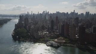 4K aerial stock footage Fly by Midtown Manhattan skyline, from Upper East Side, New York, New York Aerial Stock Footage | AX87_185