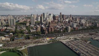 4K aerial stock footage of flying by skyscrapers, seen from East River, Brooklyn, New York Aerial Stock Footage | AX88_003