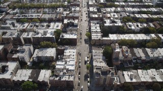 4K aerial stock footage of following 8th Avenue past row houses, Brooklyn, New York Aerial Stock Footage | AX88_025