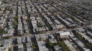 4K aerial stock footage of flying over row houses, tilt up to wider view, Brooklyn, New York Aerial Stock Footage | AX88_032